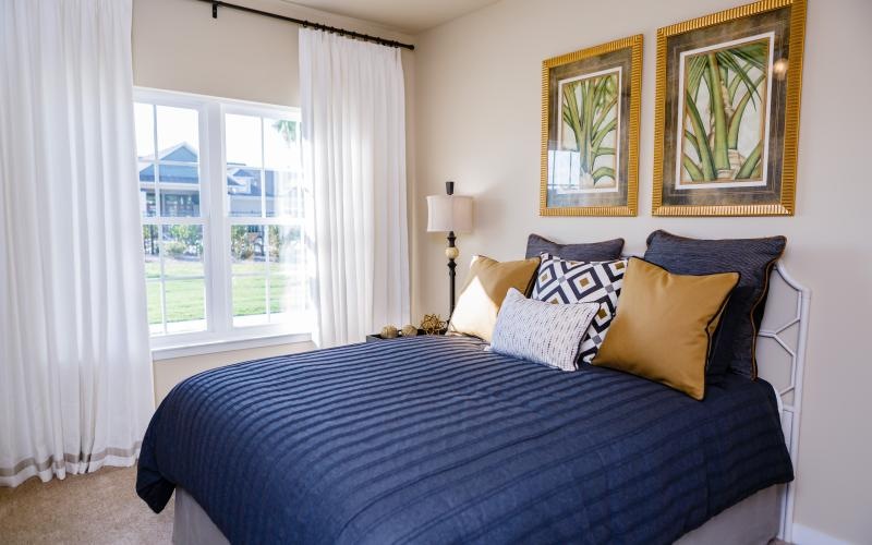 a bed with a blue and white comforter